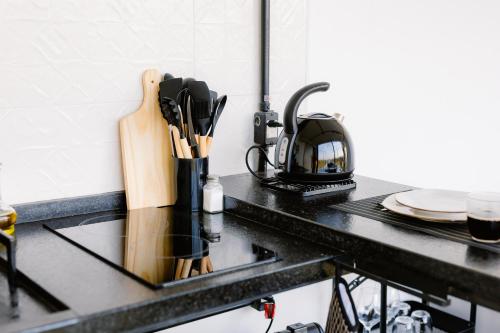 a kitchen counter with a sink with a coffee pot at Container Experience in Jacareí