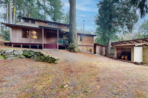 a house on a hill with a yard at Hawk's Hole in Hansville