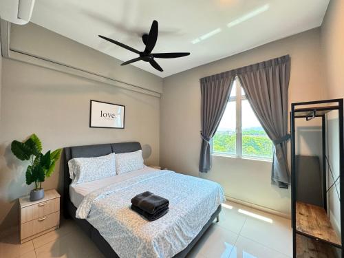 a bedroom with a bed and a ceiling fan at The Paloh Town Suites 4R2B with 2 carpark by IWH Suites in Ipoh