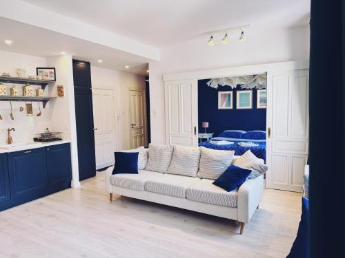 a living room with a couch and a bed at City Center Apartment in Gdańsk