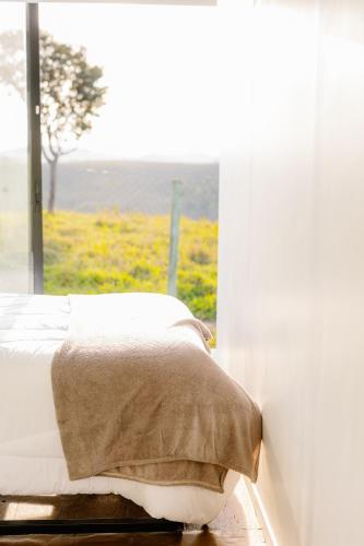 a bedroom with a bed in front of a window at Container Experience in Jacareí
