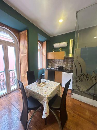 a dining room with a table and chairs in a kitchen at Sao Jorge Apartments & Suites in Lisbon
