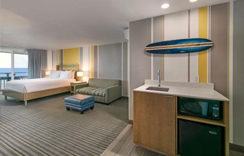 a hotel room with a bed and a television at The Wayfarer San Diego in San Diego