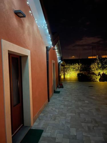a hallway of a building at night with lights at La Casetta di Lollò in Aci SantʼAntonio