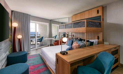a bedroom with a large bed and blue chairs at The Wayfarer San Diego in San Diego