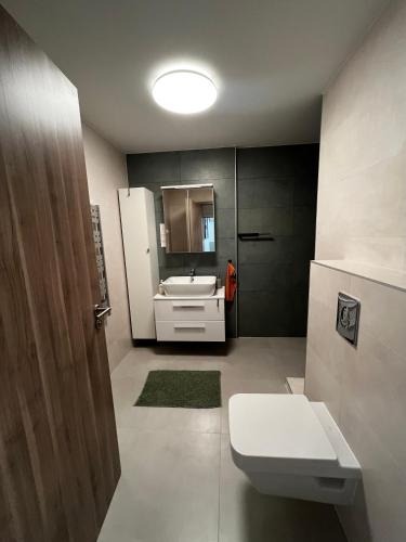 a bathroom with a white toilet and a sink at Summer Vibe Siófok - Wave in Siófok