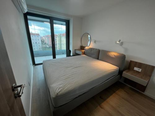 a small bedroom with a bed and a window at Summer Vibe Siófok - Wave in Siófok