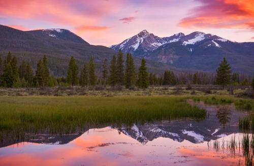 a reflection of the mountains in a lake at sunset at New Log Home, Hot Tub For 8, Views! in Tabernash