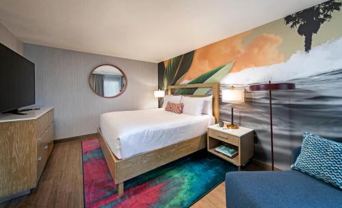 a hotel room with a bed and a painting on the wall at The Wayfarer San Diego in San Diego