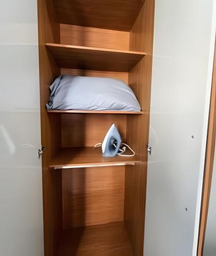a book shelf with a bed and a phone in it at 303-AP Próx Unipam e Parq expo-AR-Elevador-Garagem in Patos de Minas