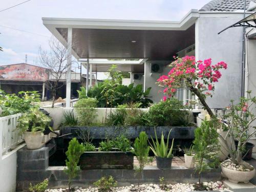 a garden with potted plants on a house at Garden Full House in Madiun