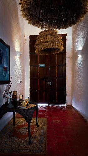 a room with a table in front of a door at Casa Gaitana - Alma Hotels in Santa Marta