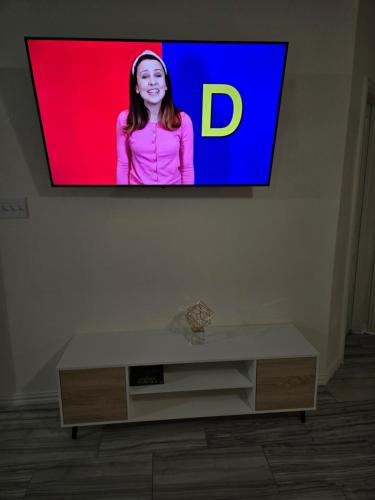 a tv screen with a woman on it in a living room at Elegant family home in Cypress