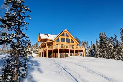 a large wooden house in the snow with trees at New Log Home, Hot Tub For 8, Views! in Tabernash