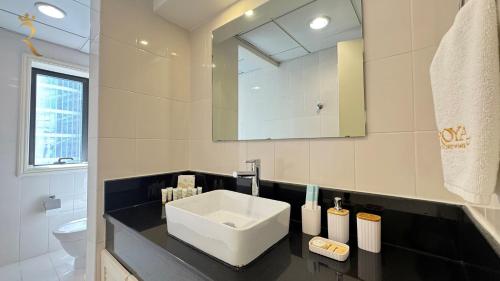 a bathroom with a sink and a toilet and a mirror at Al Raha 4BR Oasis Elegant Luxury Retreat in Abu Dhabi