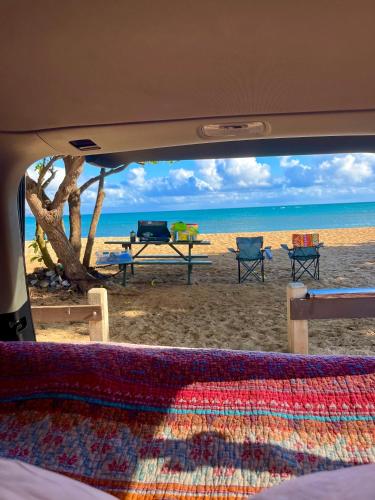 a view of a beach with a table and chairs at Campervan/Maui hosted by Go Camp Maui in Kihei
