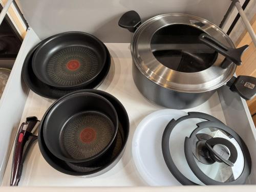a stove top with pots and pans on it at P's Wood 箱根仙石原 in Hakone