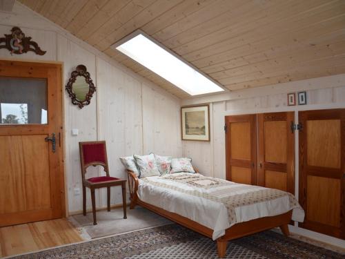 a bedroom with a bed and a skylight at Ferienwohnungen Eisele in Bad Feilnbach
