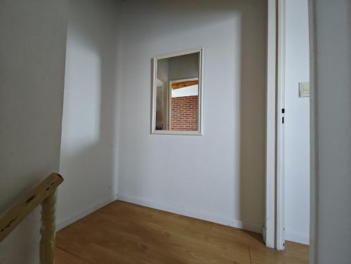 an empty room with a window in a white wall at Alborada in Tandil
