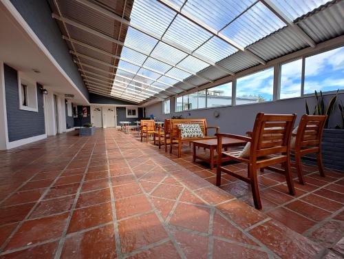 a room with chairs and tables and a skylight at Alborada in Tandil