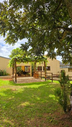 a house with a yard with a fence and a tree at El Jardín Secreto in Trinidad