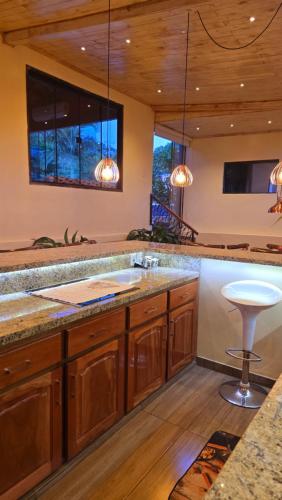 a kitchen with wooden cabinets and a large counter top at El Jardín Secreto in Trinidad