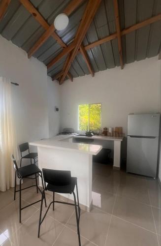 a kitchen with a table and chairs in a room at Apartamento Media Luna in Cabrera