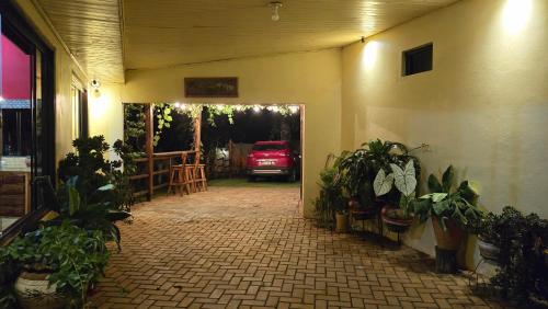 an entrance to a garage with a red car parked at El Jardín Secreto in Trinidad