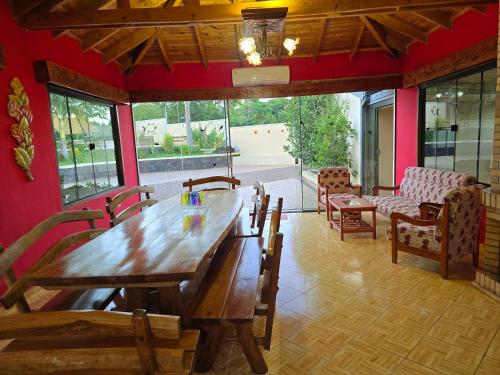 a dining room with a wooden table and chairs at El Jardín Secreto in Trinidad