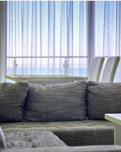 a couch and chairs in a living room with a table at Paradise beachfront view 1 in Bar