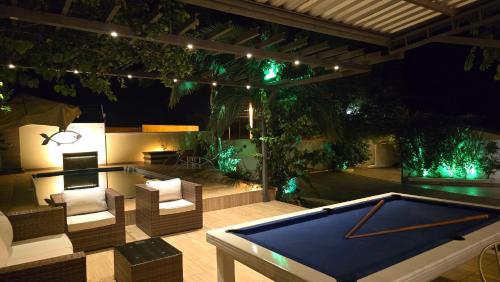 a ping pong table on a patio with a pool at El Jardín Secreto in Trinidad