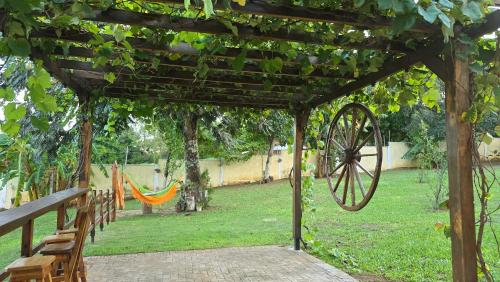 a wooden pergola with a hammock in a park at El Jardín Secreto in Trinidad