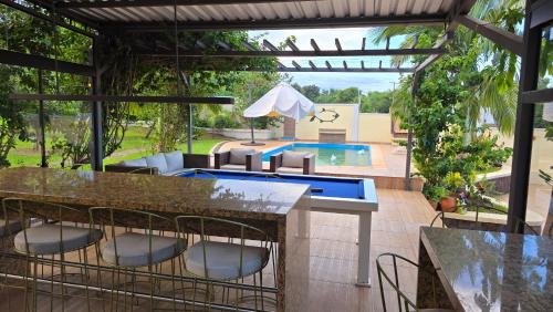 a patio with a table and chairs and a swimming pool at El Jardín Secreto in Trinidad