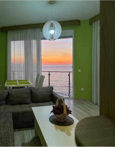 a living room with a couch and a view of the ocean at Paradise beachfront view 1 in Bar