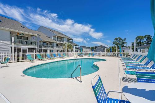 a swimming pool with blue and white chairs at 33H-Golf Colony in Surfside in Myrtle Beach