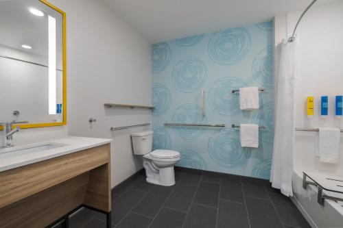 a bathroom with a toilet and a sink at Tru By Hilton Oshkosh in Oshkosh