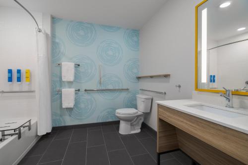 a bathroom with a toilet and a sink at Tru By Hilton Oshkosh in Oshkosh
