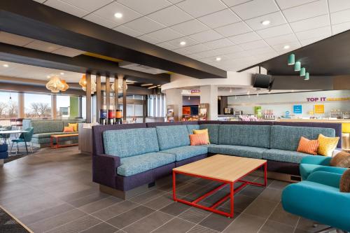a waiting room with a couch and a table at Tru By Hilton Oshkosh in Oshkosh