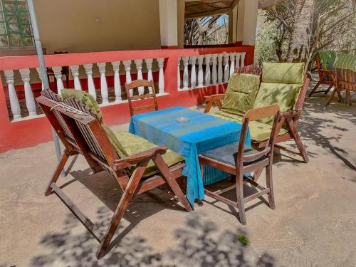 a blue table and chairs on a porch at Kuba Lodge in Gunjur