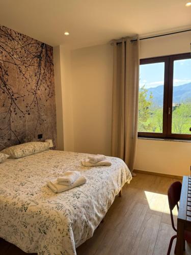 a bedroom with a bed and a large window at B&B Luna Verde in Mercato San Severino