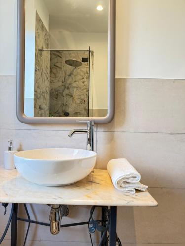 a bathroom with a white sink and a mirror at B&B Luna Verde in Mercato San Severino