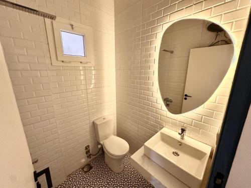 a bathroom with a sink and a toilet and a mirror at Nomads Hostel in Dahab