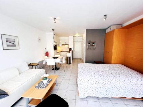 a living room with a bed and a couch at Studio in Wenduine near the Beach in Wenduine