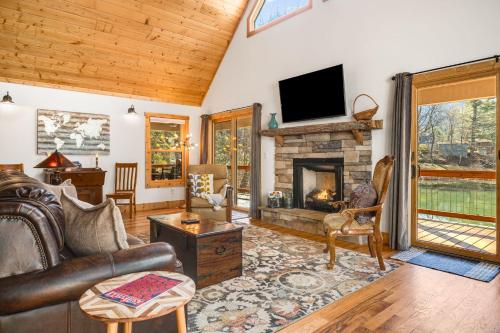 a living room with a couch and a fireplace at Serenade Collection by Carolina Mornings in Hendersonville