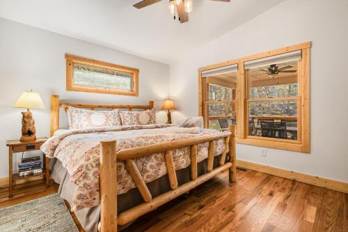 a bedroom with a wooden bed and a window at Serenade Collection by Carolina Mornings in Hendersonville
