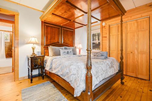 a bedroom with a canopy bed with a wooden ceiling at Serenade Collection by Carolina Mornings in Hendersonville