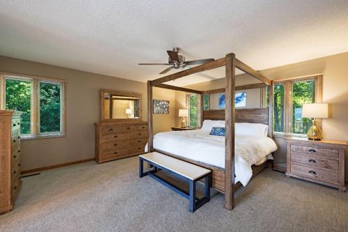 a bedroom with a canopy bed and windows at Sunset Peaks by Carolina Mornings in Asheville