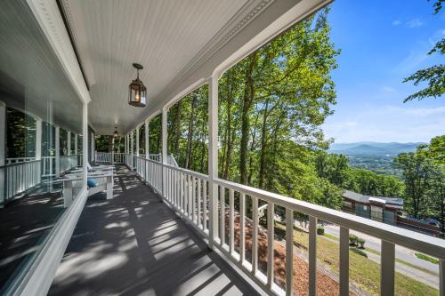 a porch with a view of the mountains at Magic on the Hill by Carolina Mornings in Asheville