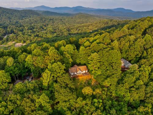 an aerial view of a house in the middle of a forest at Sunset Peaks by Carolina Mornings in Asheville