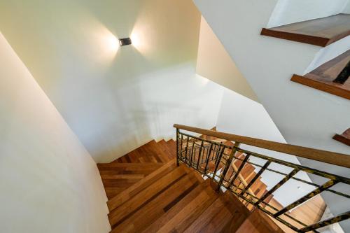 a staircase in a house with a light on the wall at La Ferringhi Villa - Tropical Collection, by ALV in Batu Ferringhi